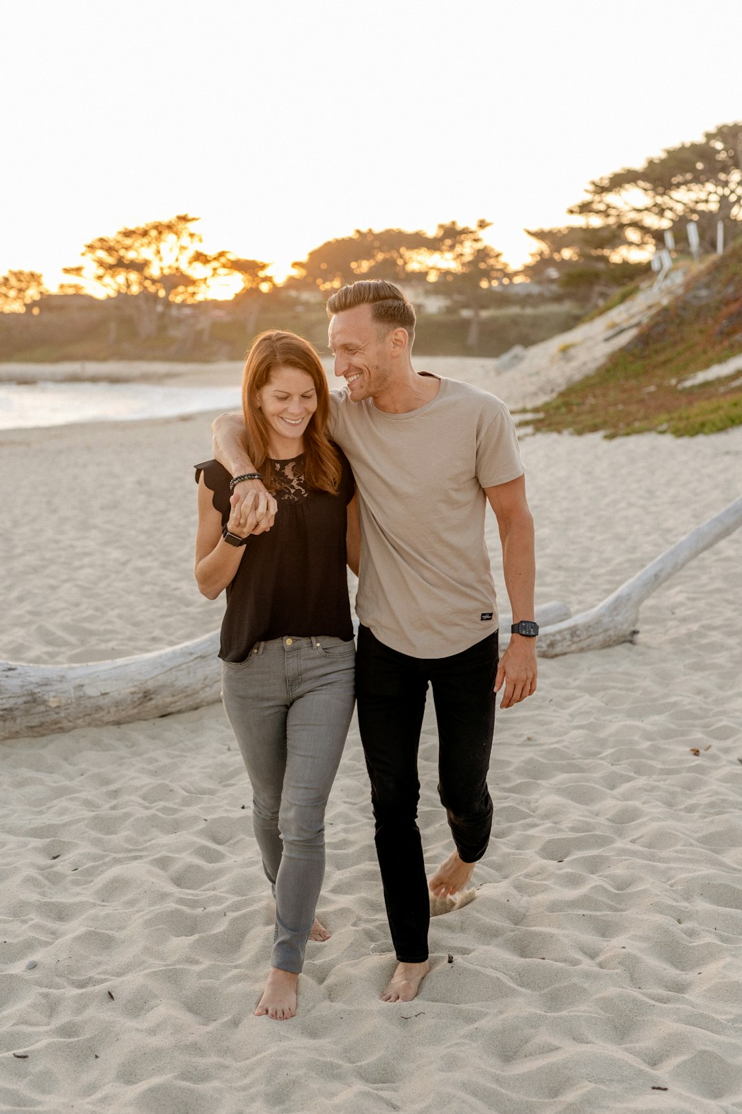 Photo by Allen Taylor man and woman standing on beach during daytime